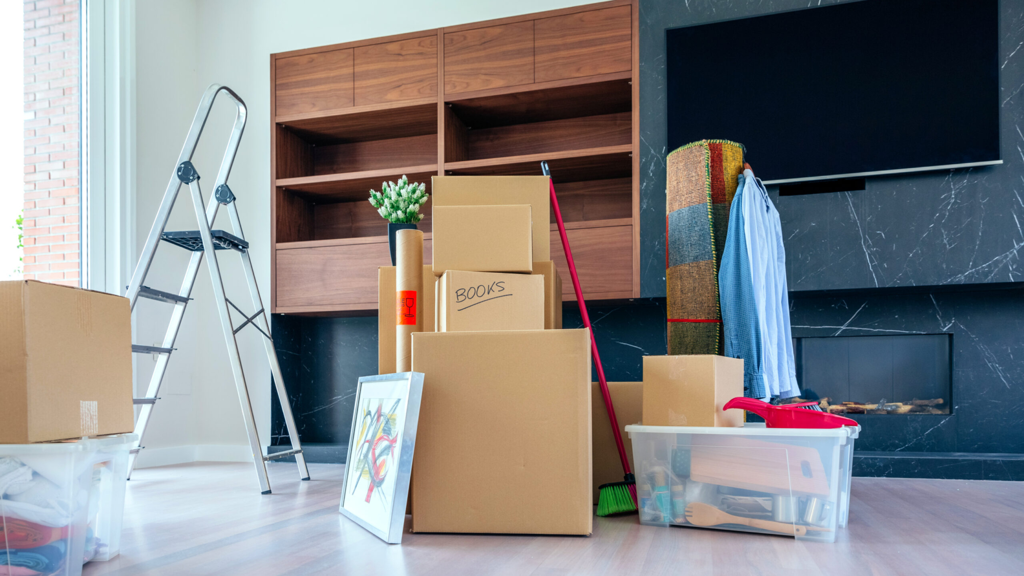 Large living room with stack of moving boxes